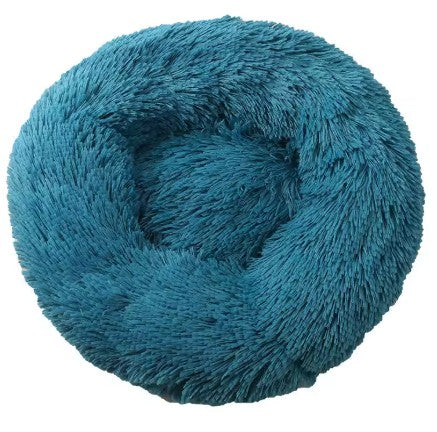 Coiled teal plush yarn on a white background