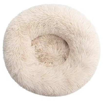 Fluffy beige pet bed with a cat inside on a white background