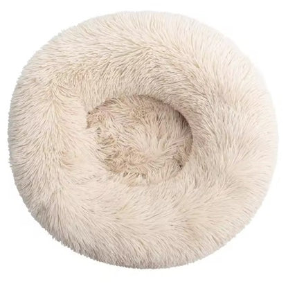Fluffy beige pet bed with a cat inside on a white background