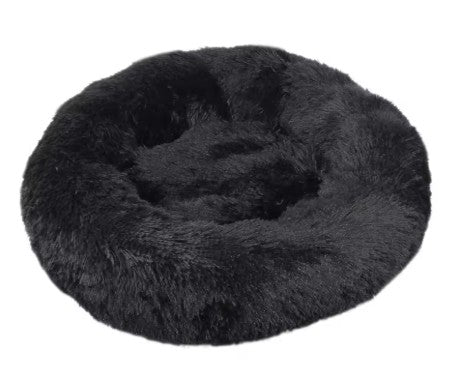 Black fluffy donut pet bed on a white background