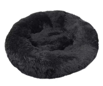 Black fluffy donut pet bed on a white background