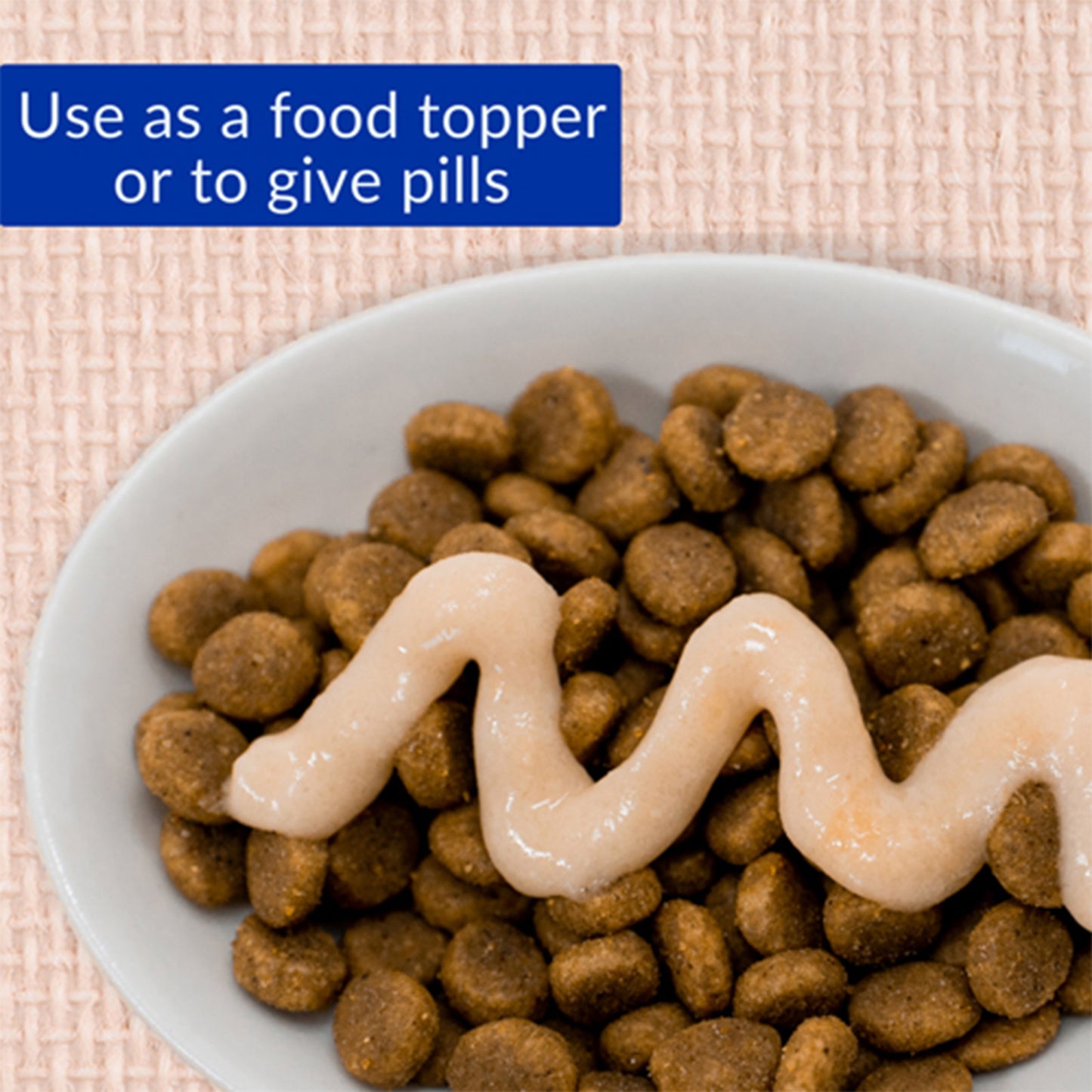 Dog food with a food topper on a textured surface